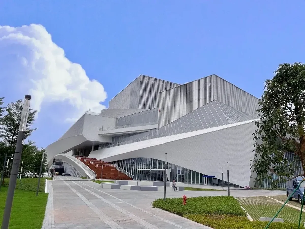 Close perspective of the angular ceramic louvers and red terraced outdoor amphitheater steps