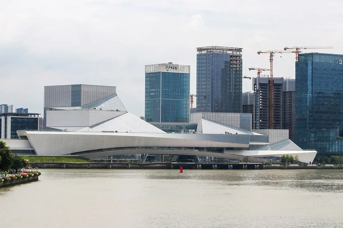 Wide telephoto view across the Pearl River showing the three hundred and sixty meter long white cultural complex