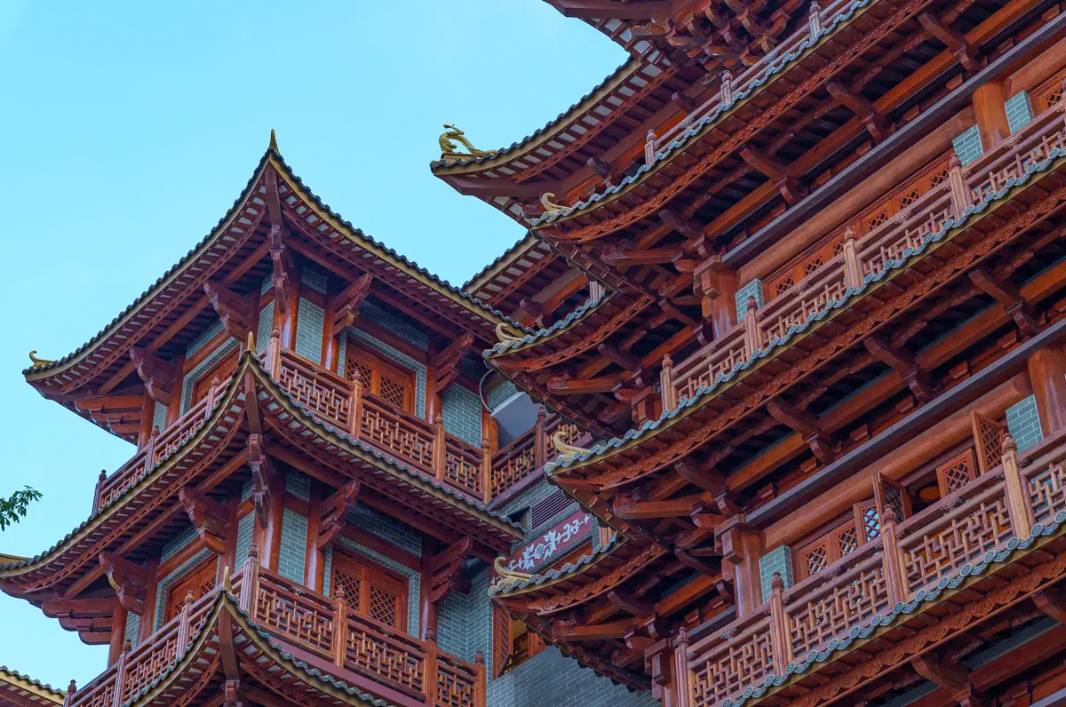 Close-up detail of multi-tier interlocking timber dougong brackets and eaves at Dafo Temple in Guangzhou