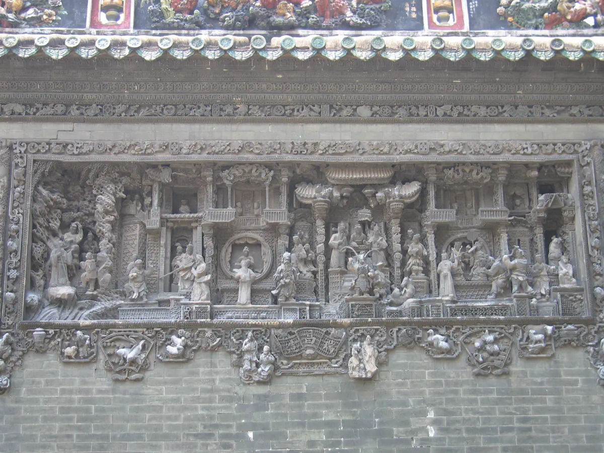 Intricate water-polished brick carving panel on Chen Clan Ancestral Hall wall depicting Water Margin heroes gathering at Liangshan