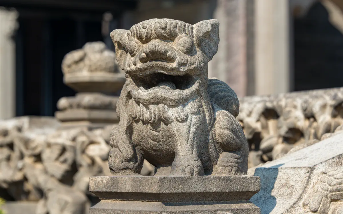 Delightfully detailed small granite stone lion carved atop a balustrade pillar on Juxian Hall terrace in Chen Clan Ancestral Hall