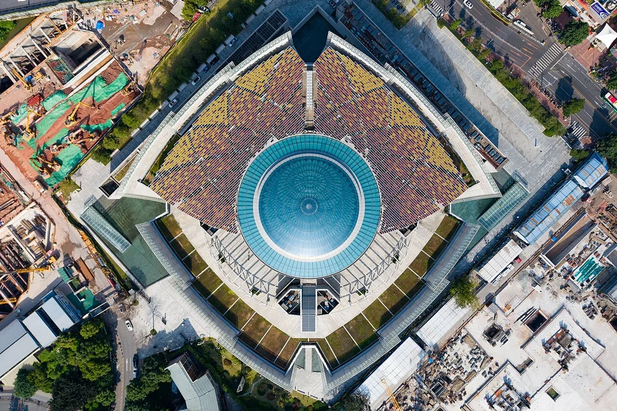Direct top-down aerial perspective showing the geometric symmetry of the central glass dome and solar panels