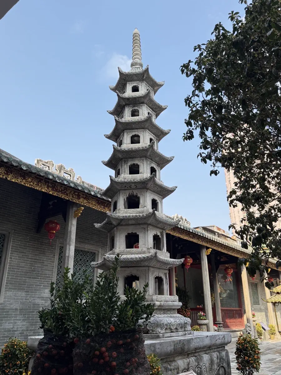 Seven-tier octagonal white marble relic pagoda standing in the courtyard of Hualin Temple against a clear sky