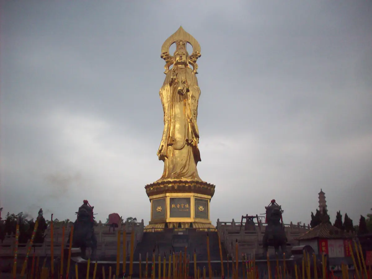The 40.88-metre tall gilded bronze Guanyin statue facing Shiziyang Bay with incense burners in front