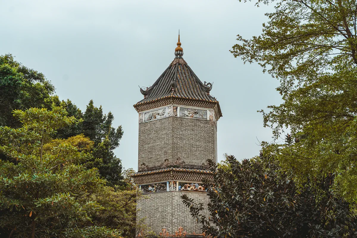 Shenjing Pagoda rising above verdant banyan trees in Shenjing Ancient Village