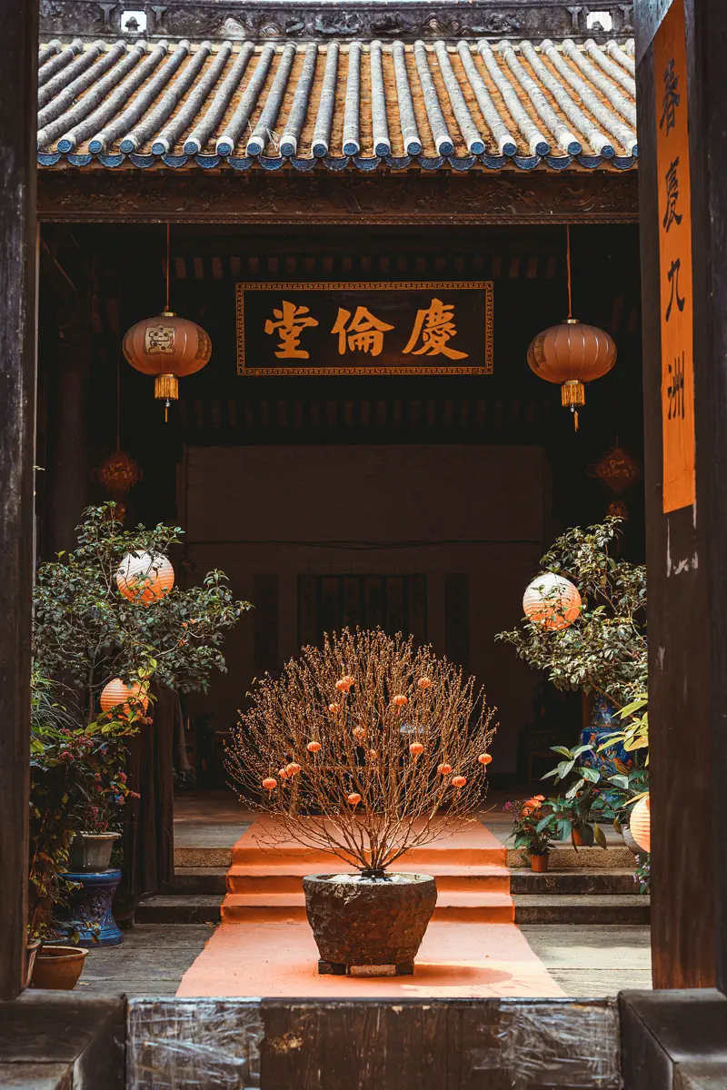 Courtyard interior of Qinglun Ancestral Hall with potted bonsai and tiled roofs