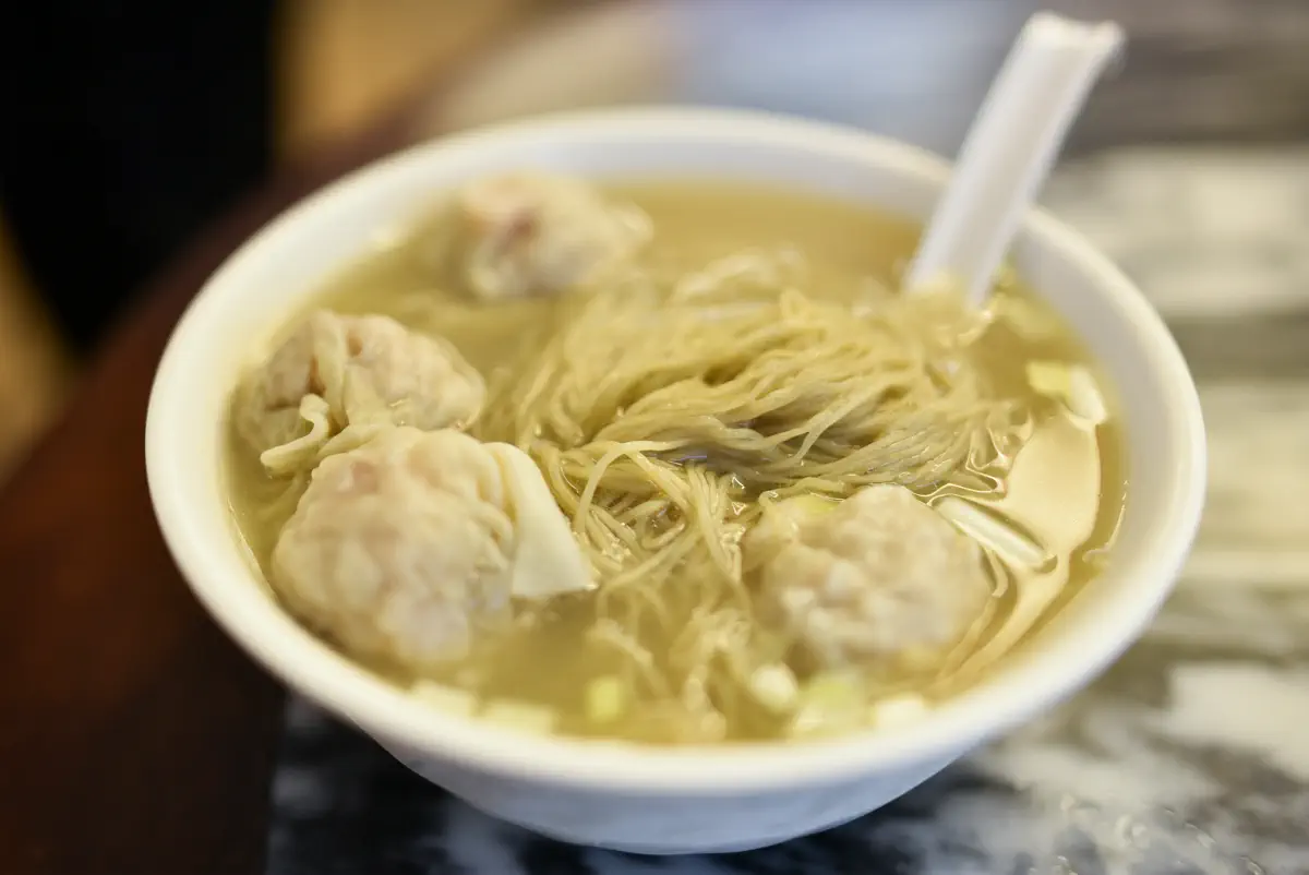 Traditional Cantonese wonton noodles with springy jook-sing noodles and shrimp wontons in clear broth