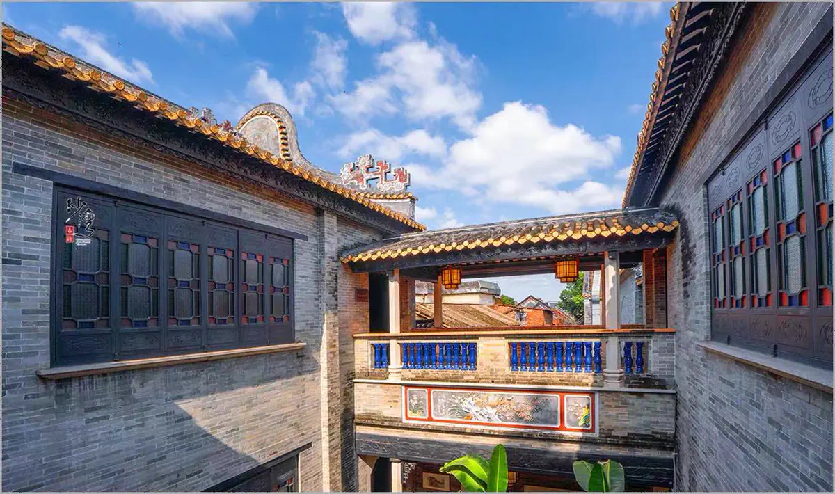 Traditional Lingnan mansion interior courtyard with wood-lattice windows and colored glass