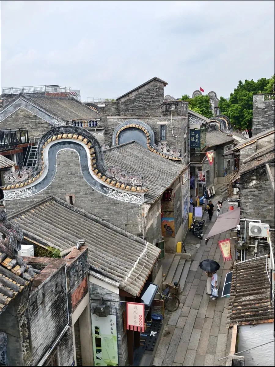 Aerial view of granite-paved alleys and layered wok-ear gables in Shawan Ancient Town
