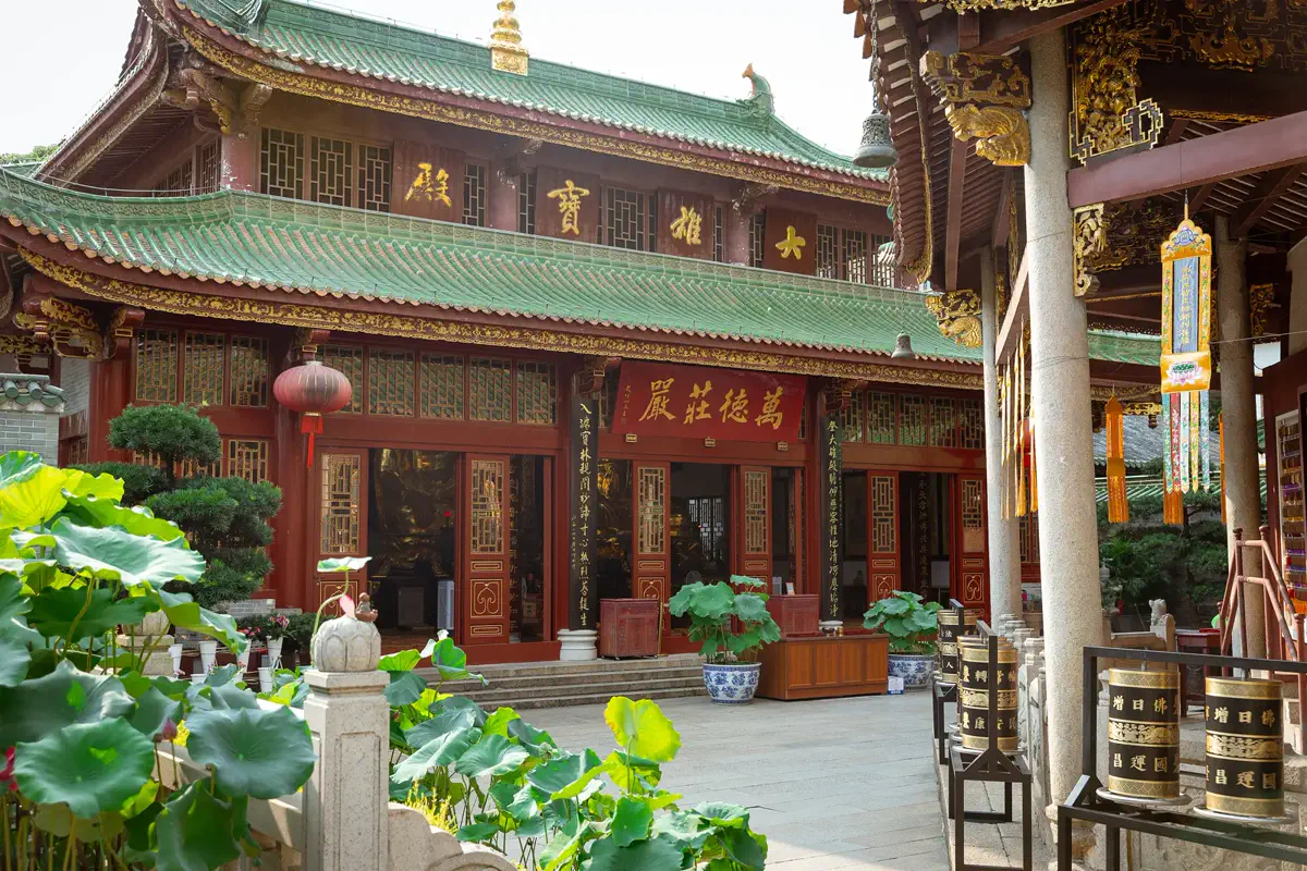 Mahavira Hall at the Temple of the Six Banyan Trees with green-tiled roofs and courtyard lotus