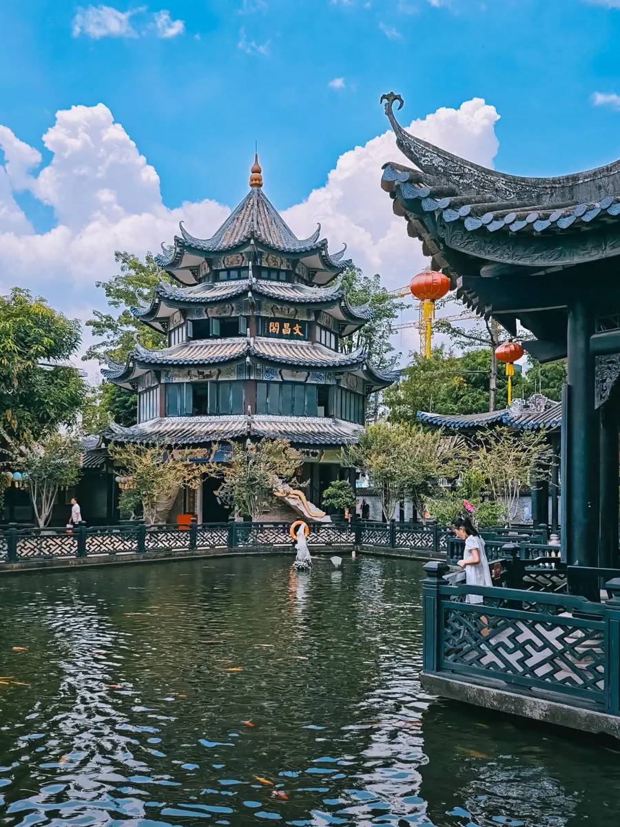 The three-tiered octagonal Wenchang Pavilion standing proudly over the expansive koi pond in the landscaped rear garden of Yuyin Shanfang